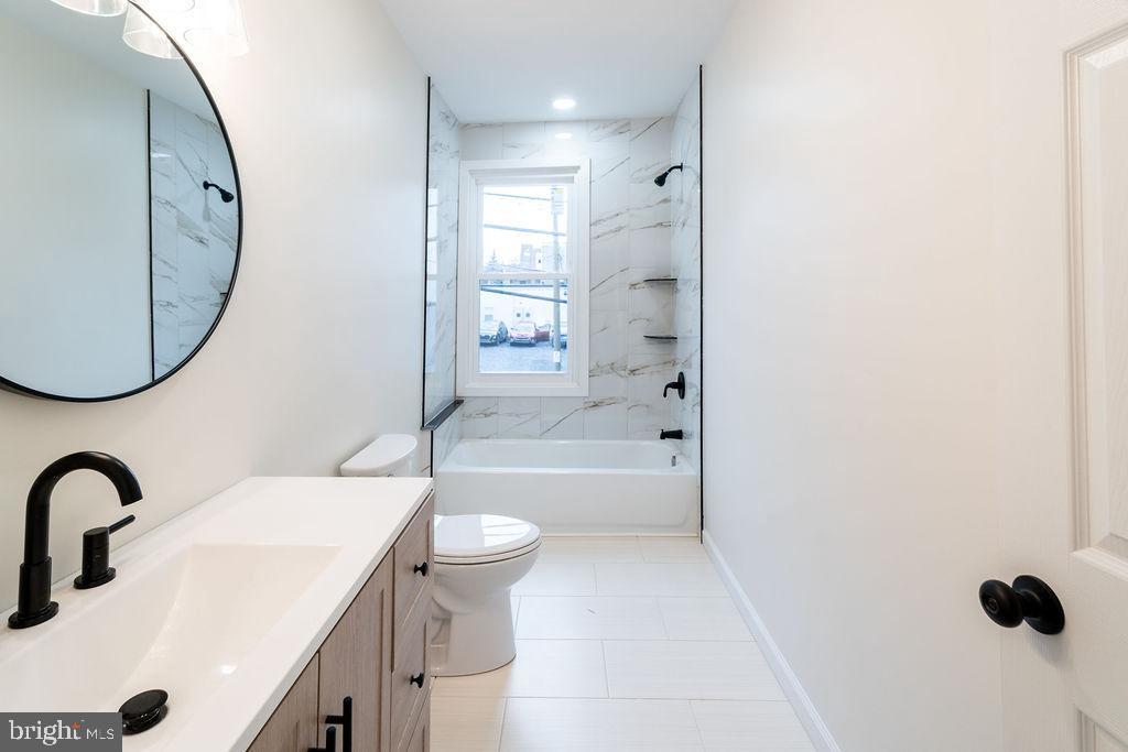 20 West Raspberry Street Bethlehem, PA 18018 - Photo 19 of 32 a bathroom with a sink a toilet and a mirror