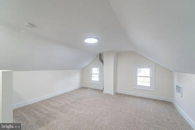 an empty room with windows and entrance