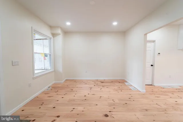 a view of a big room with wooden floor and bedroom