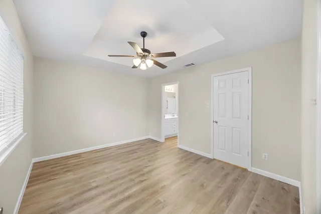 wooden floor in an empty room with a window