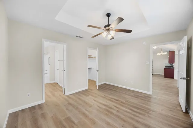 a view of a big room with wooden floor and windows in a room