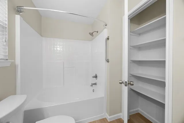 a bathroom with a bathtub and toilet