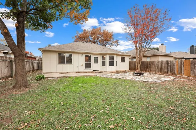 a view of a yard with a house and a large tree