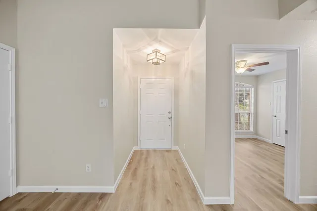 a view of a hallway with wooden floor