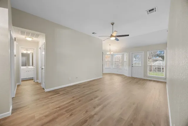 wooden floor in an empty room with a window