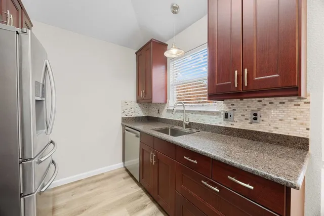 a kitchen with a sink and a refrigerator