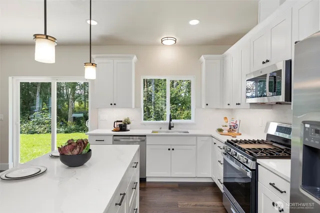 a kitchen with a sink a stove and a window