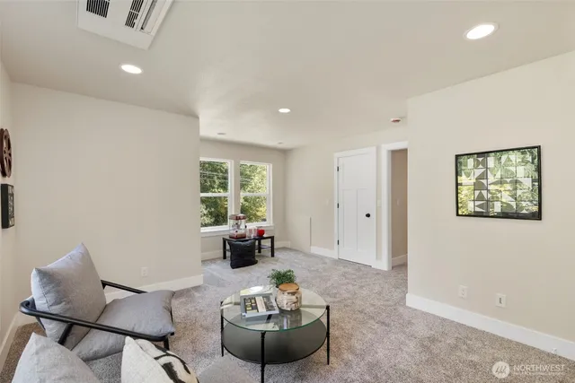 a living room with furniture and a potted plant