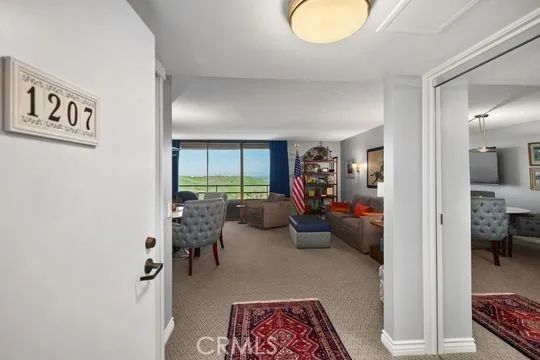 a view of a livingroom with furniture and floor to ceiling window