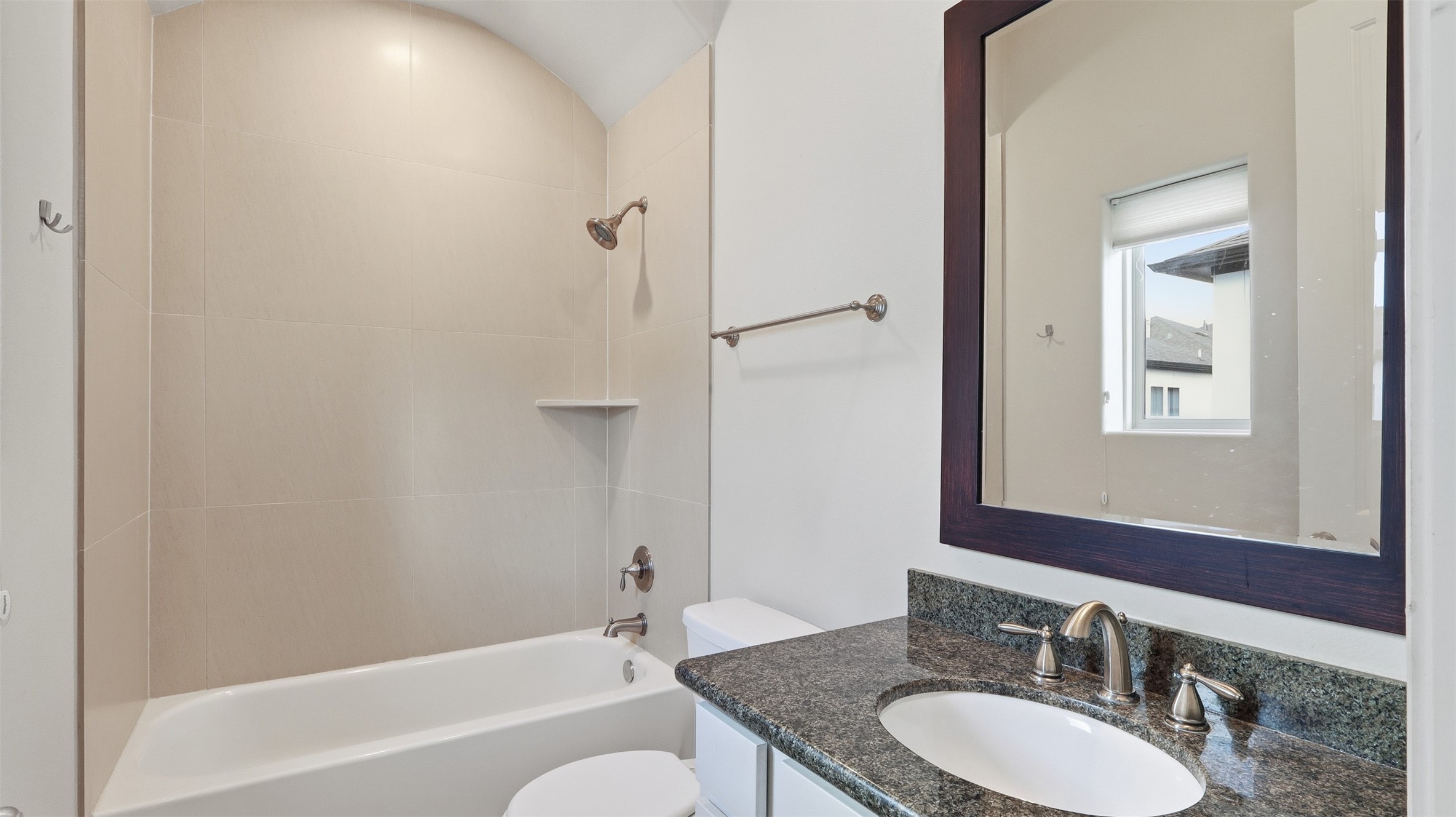 704 Paige Street Houston, TX 77003 - Photo 25 of 41 a bathroom with a granite countertop sink and a mirror