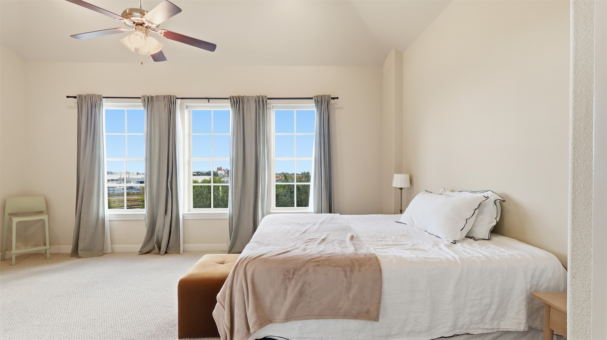 704 Paige Street Houston, TX 77003 - Photo 26 of 41 a bedroom with a large bed and a chandelier