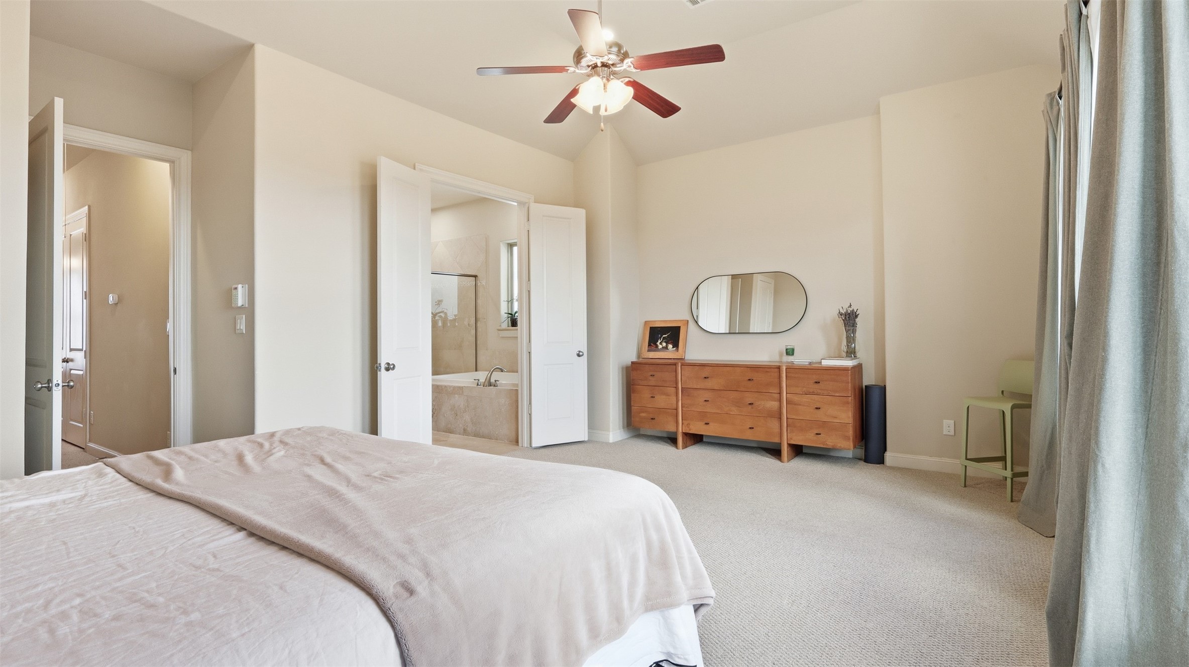 704 Paige Street Houston, TX 77003 - Photo 27 of 41 a bedroom with a bed a chandelier and dresser