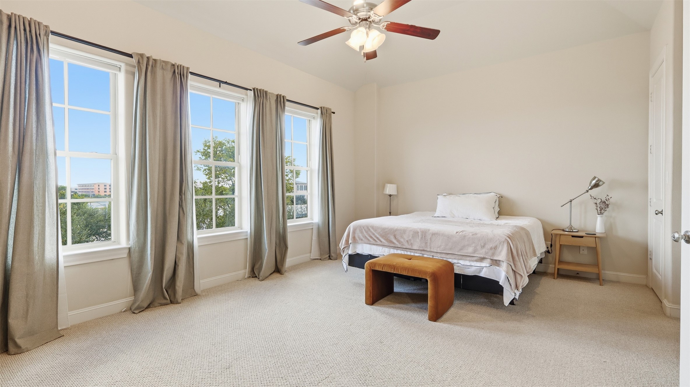 704 Paige Street Houston, TX 77003 - Photo 28 of 41 a spacious bedroom with a bed and a chandelier
