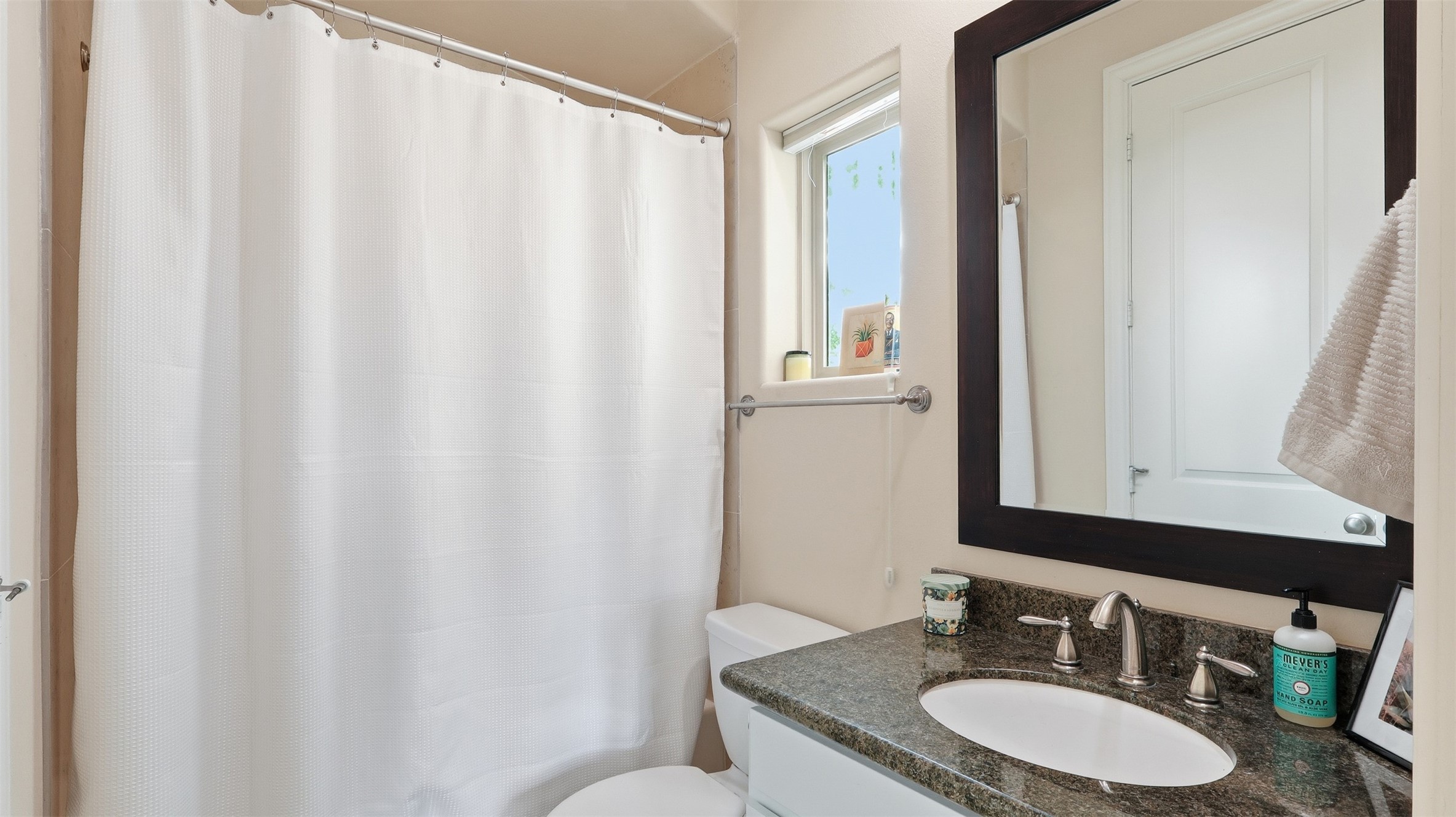 704 Paige Street Houston, TX 77003 - Photo 7 of 41 a bathroom with a granite countertop sink and a mirror