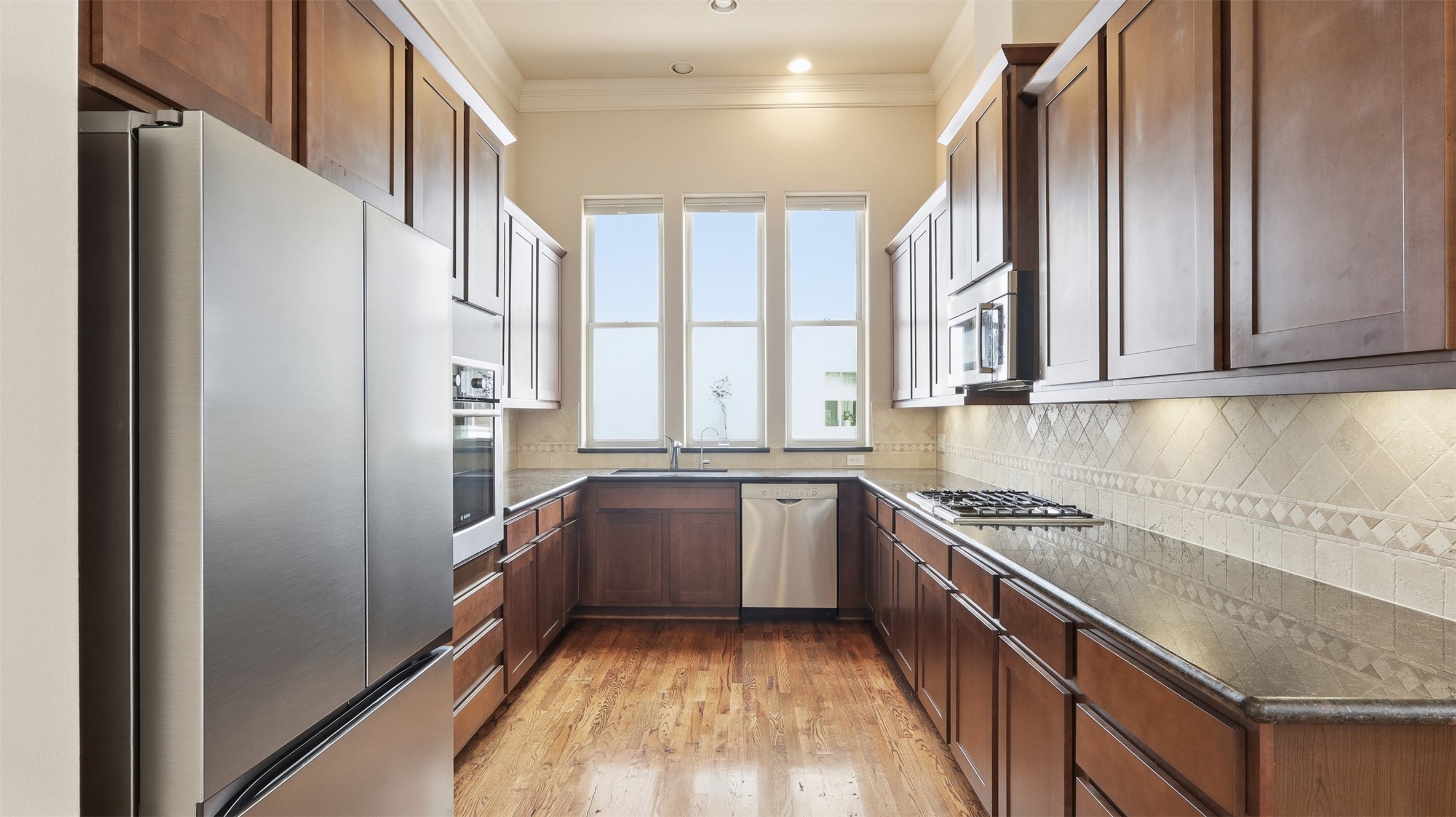 704 Paige Street Houston, TX 77003 - Photo 9 of 41 a kitchen with stainless steel appliances granite countertop a stove and a refrigerator