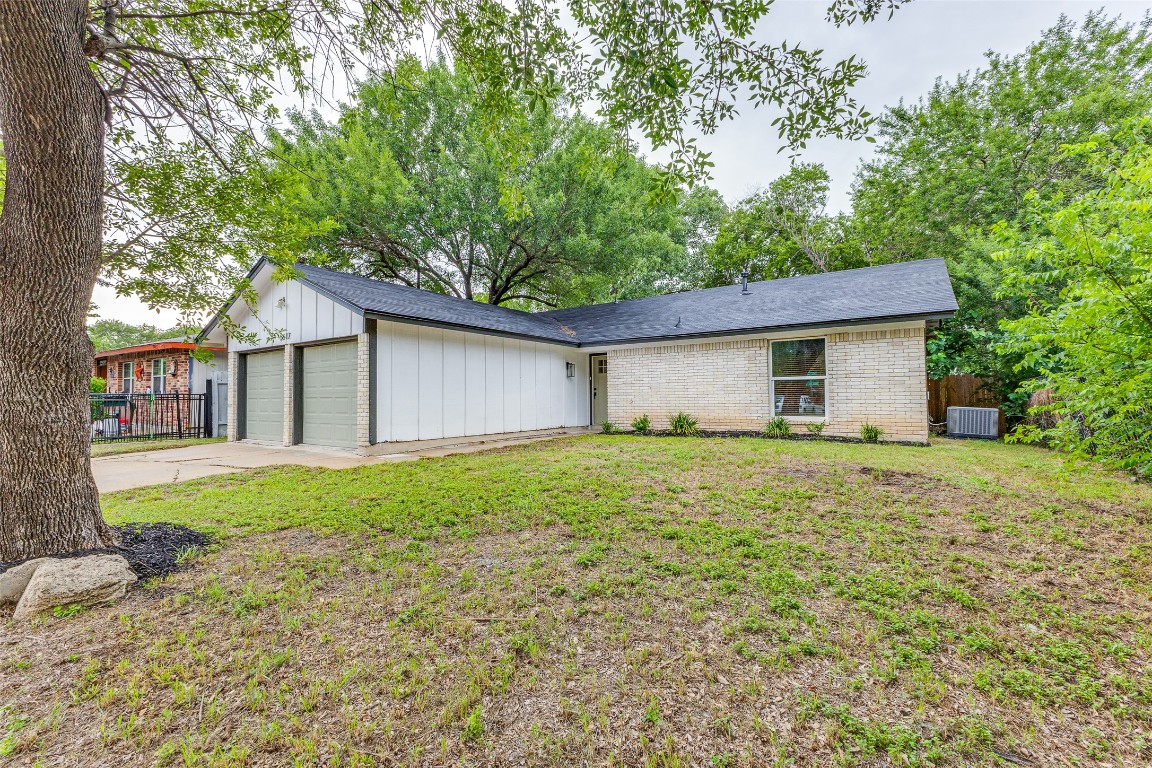 5617 Tallow Tree Drive Austin, TX 78744 - Photo 11 of 25 a view of a house with a yard and large tree