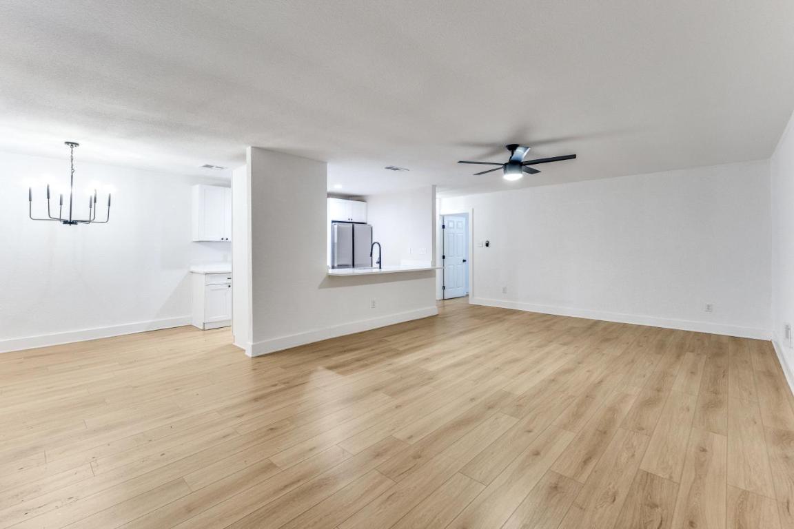 5617 Tallow Tree Drive Austin, TX 78744 - Photo 12 of 25 wooden floor in an empty room
