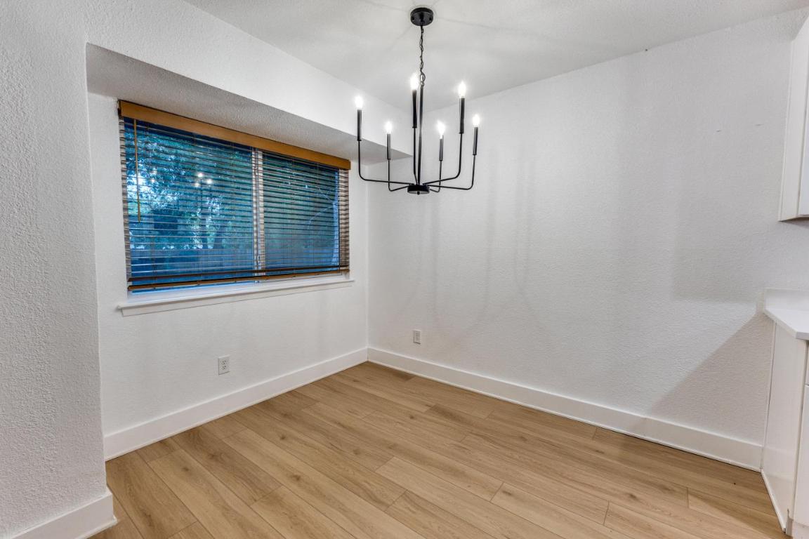 5617 Tallow Tree Drive Austin, TX 78744 - Photo 13 of 25 a view of empty room with wooden floor fan and window