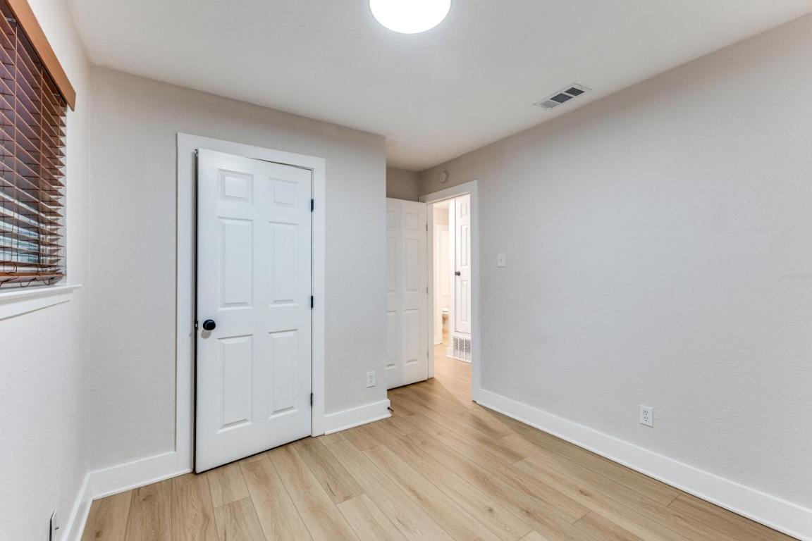 5617 Tallow Tree Drive Austin, TX 78744 - Photo 21 of 25 a view of an empty room and wooden floor