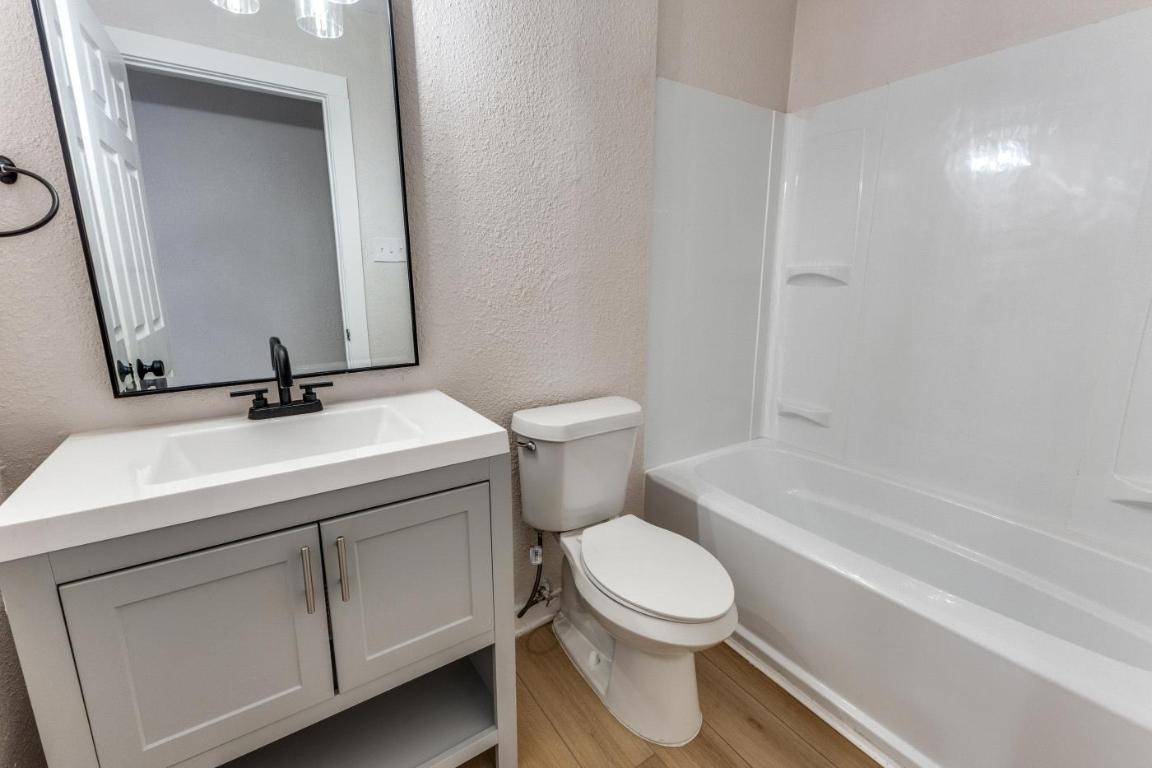 5617 Tallow Tree Drive Austin, TX 78744 - Photo 10 of 25 a bathroom with a sink a toilet and shower