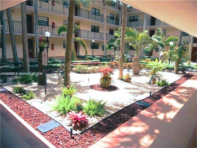 10845 Southwest 112th Avenue, Unit 211 Miami, FL 33176 - Photo 2 of 12 a view of a flower in the corridor