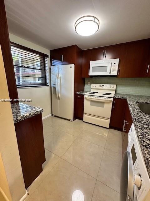 10845 Southwest 112th Avenue, Unit 211 Miami, FL 33176 - Photo 5 of 12 a kitchen with stainless steel appliances granite countertop a refrigerator a stove and a refrigerator