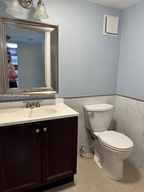 10845 Southwest 112th Avenue, Unit 211 Miami, FL 33176 - Photo 7 of 12 a bathroom with a toilet sink and mirror