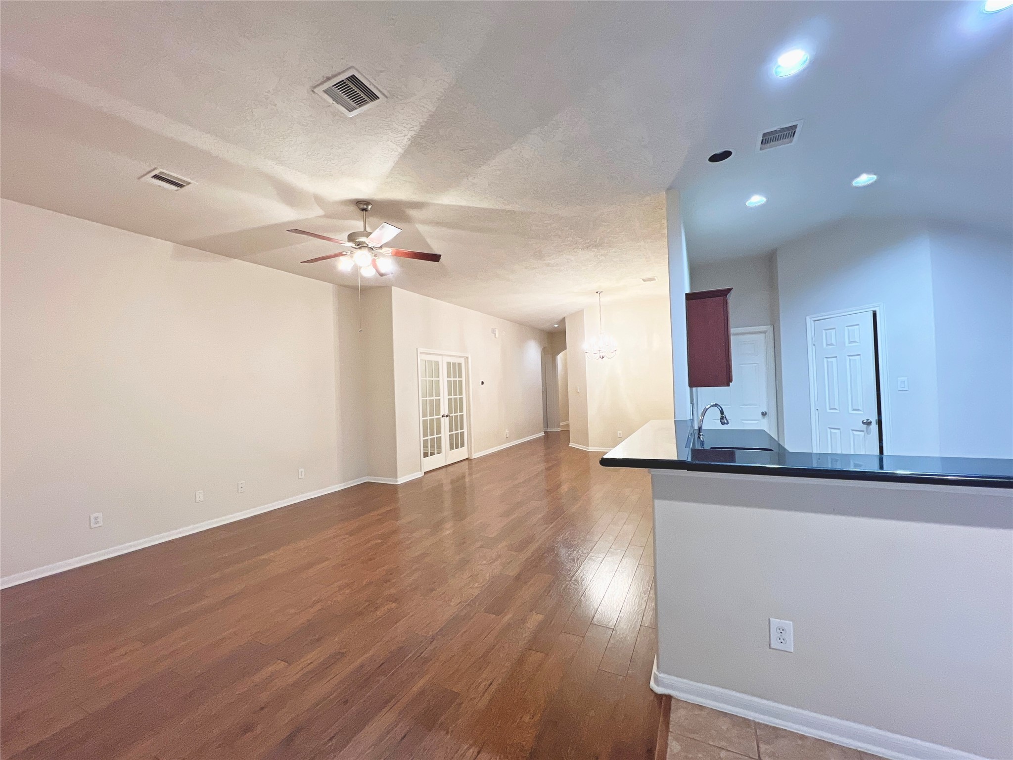 13306 South Point Lane Houston, TX 77034 - Photo 5 of 16 an empty room with wooden floor and a ceiling fan