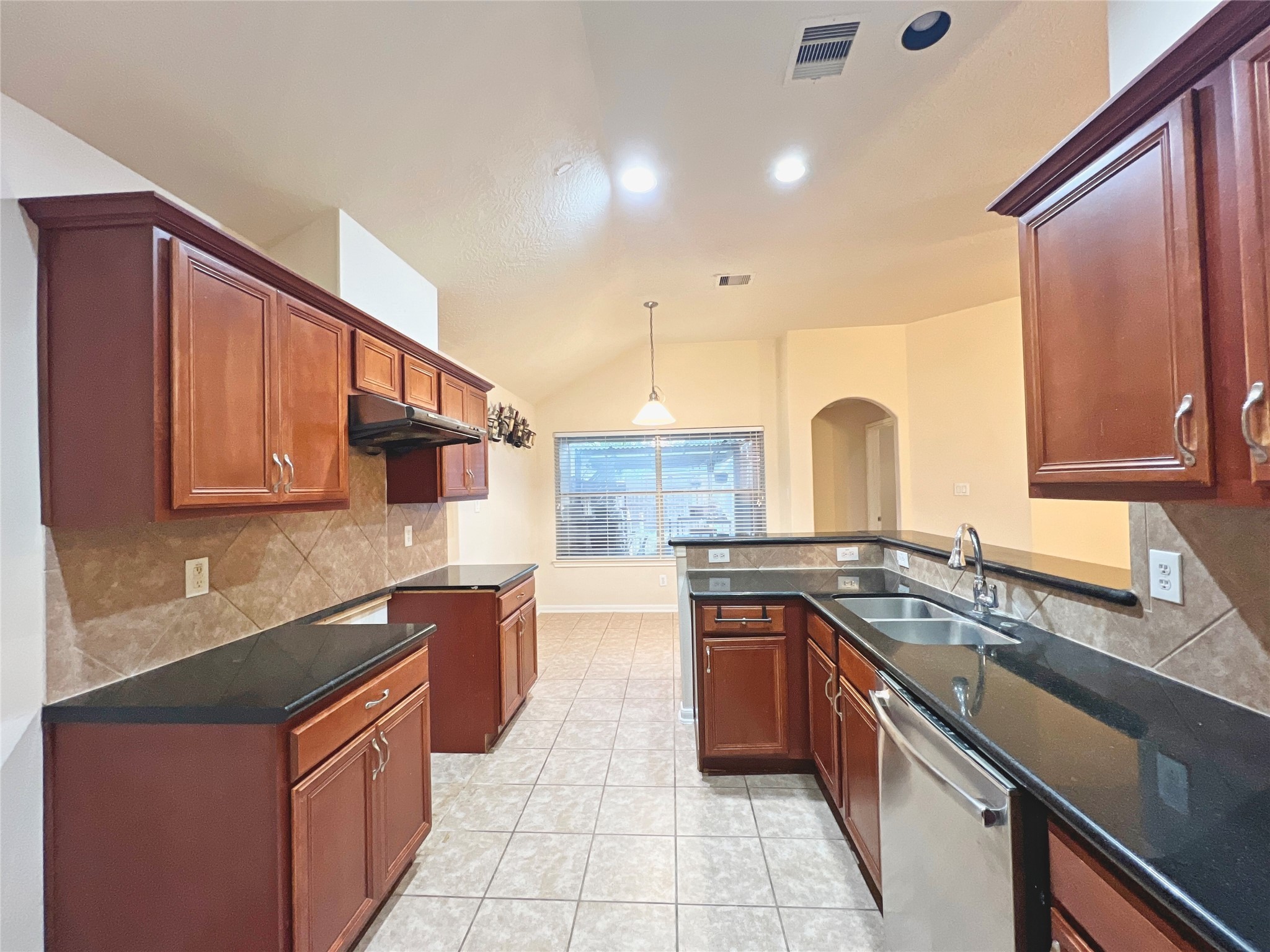 13306 South Point Lane Houston, TX 77034 - Photo 6 of 16 a kitchen with stainless steel appliances granite countertop a stove a sink and a microwave