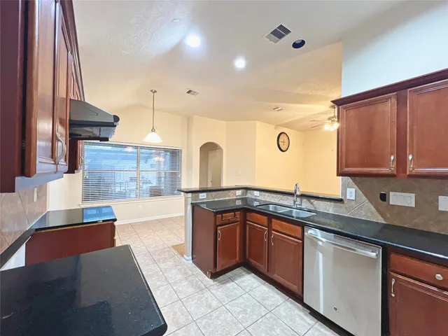 a kitchen with stainless steel appliances granite countertop a sink and cabinets