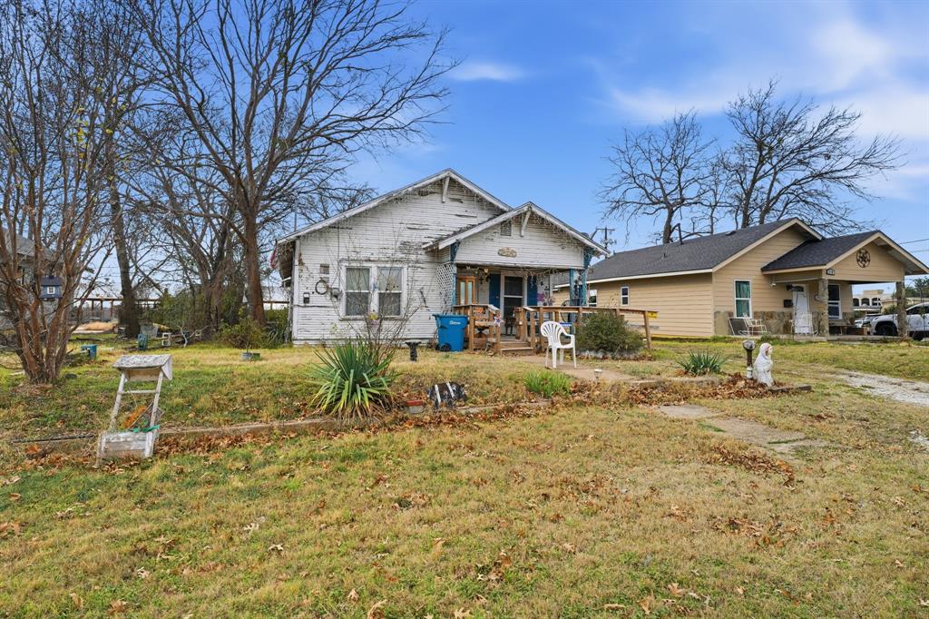 514 North Lee Street Sherman, TX 75090 - Photo 4 of 18 a view of house with a big yard and large trees
