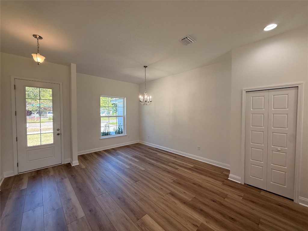 96076 Pirates Bluff Road Yulee, FL 32097 - Photo 11 of 22 an empty room with wooden floor and window