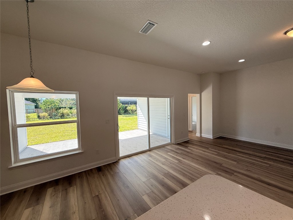 96076 Pirates Bluff Road Yulee, FL 32097 - Photo 8 of 22 a view of an empty room with window and wooden floor