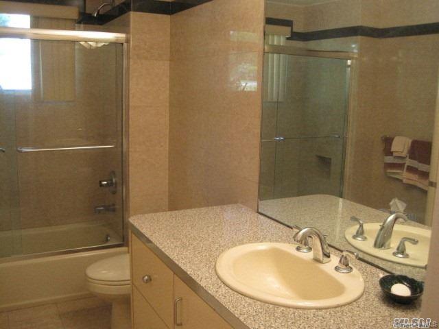 26 Ridge Drive East Roslyn, NY 11576 - Photo 18 of 28 a bathroom with a sink toilet and shower