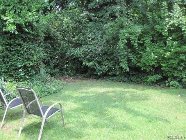26 Ridge Drive East Roslyn, NY 11576 - Photo 24 of 28 a view of a yard with chairs