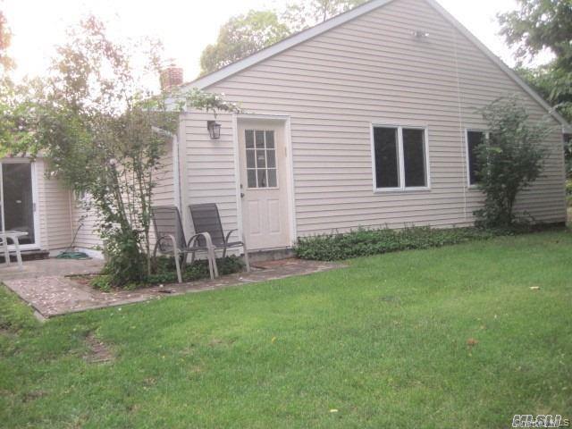 26 Ridge Drive East Roslyn, NY 11576 - Photo 27 of 28 a backyard of a house with table and chairs