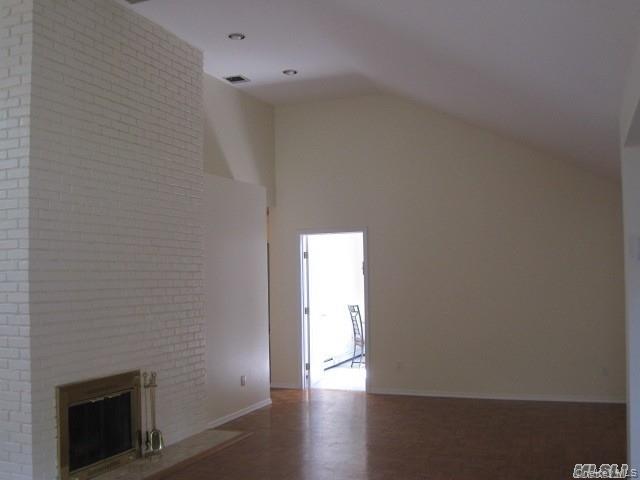 26 Ridge Drive East Roslyn, NY 11576 - Photo 7 of 28 a view of an empty room with wooden floor
