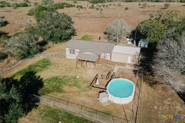 an aerial view of a house with outdoor space