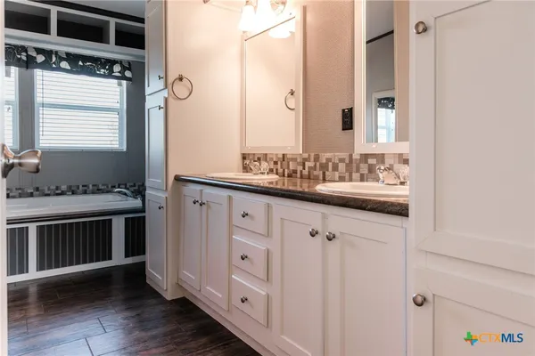 a bathroom with a sink and a mirror