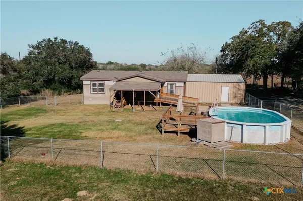 a view of a house with backyard porch and sitting area