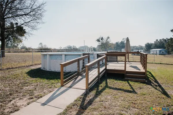 a view of a lake with wooden stairs and bench next to a lake