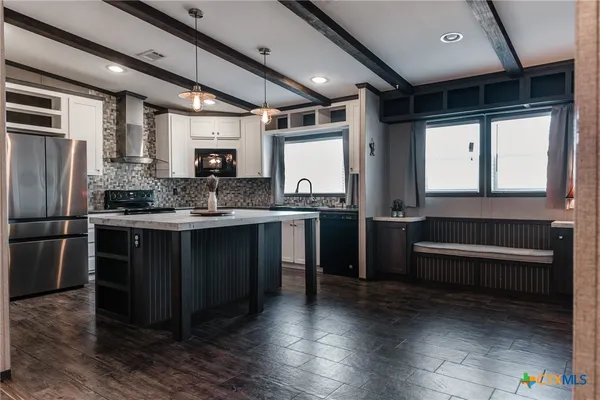 a kitchen with stainless steel appliances granite countertop a stove a sink and a refrigerator