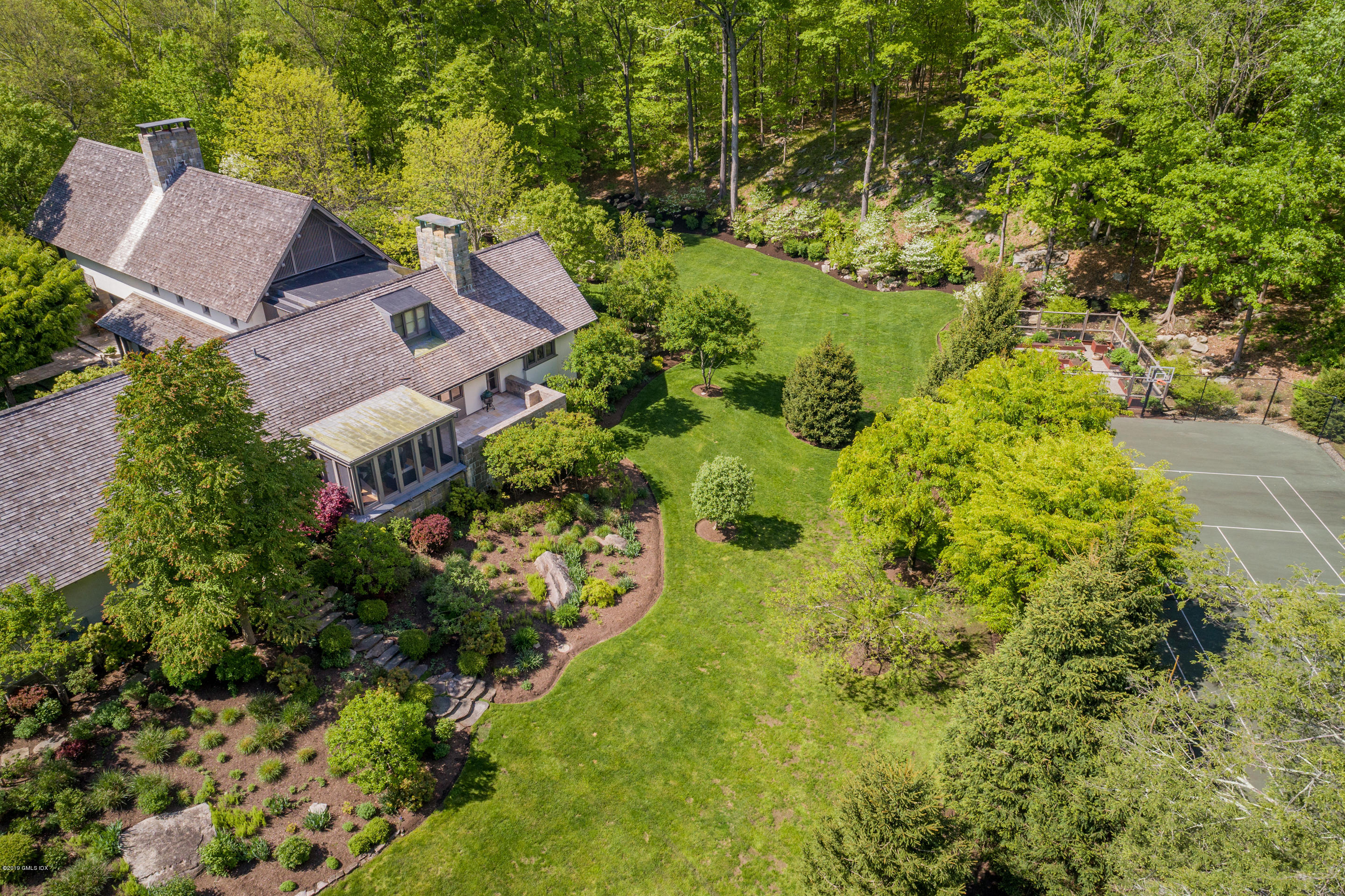 373 Riverbank Road Stamford, CT 06903 - Photo 17 of 35 an aerial view of a house with a yard