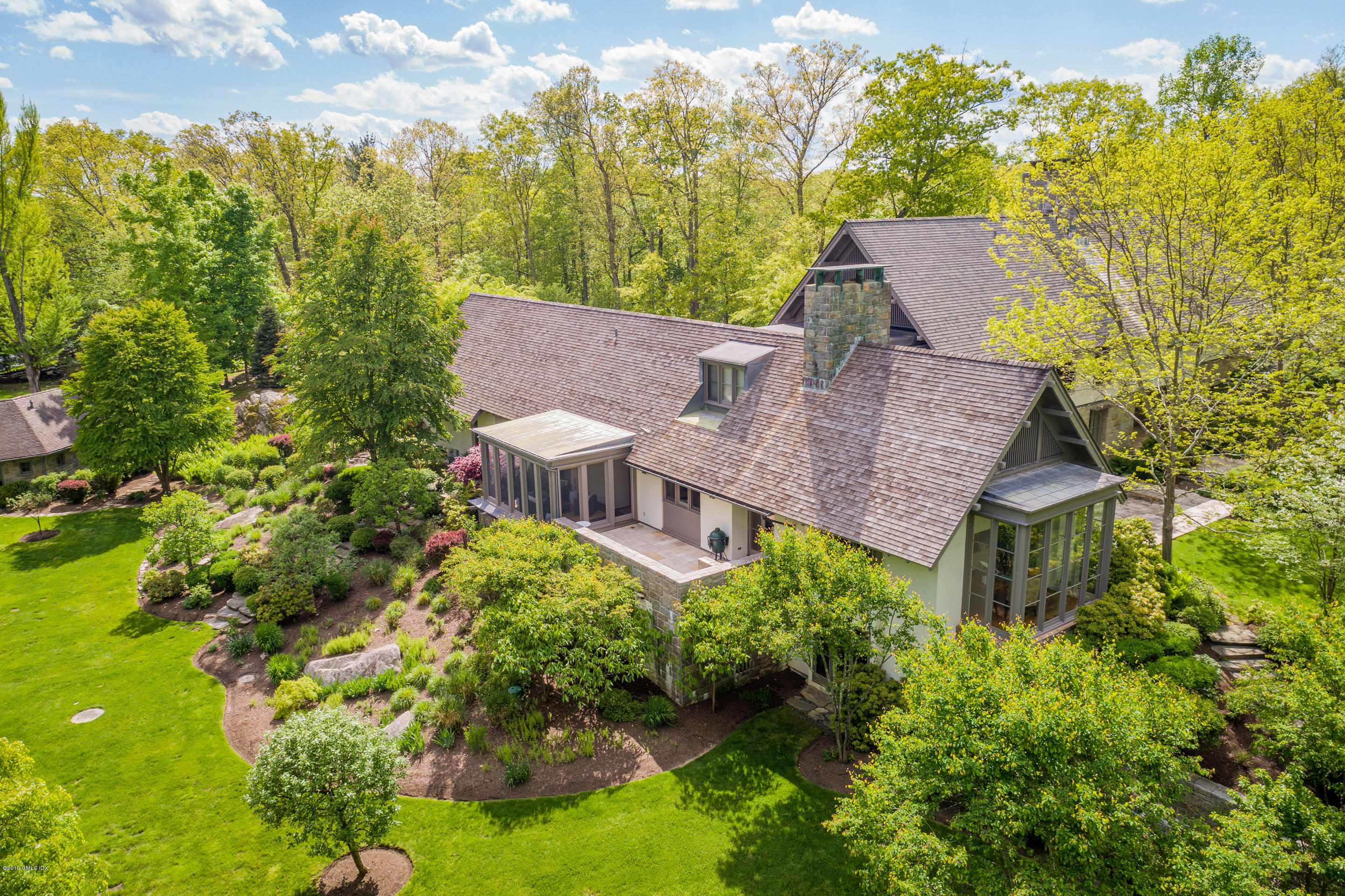 373 Riverbank Road Stamford, CT 06903 - Photo 18 of 35 aerial view of a house with a yard and large trees