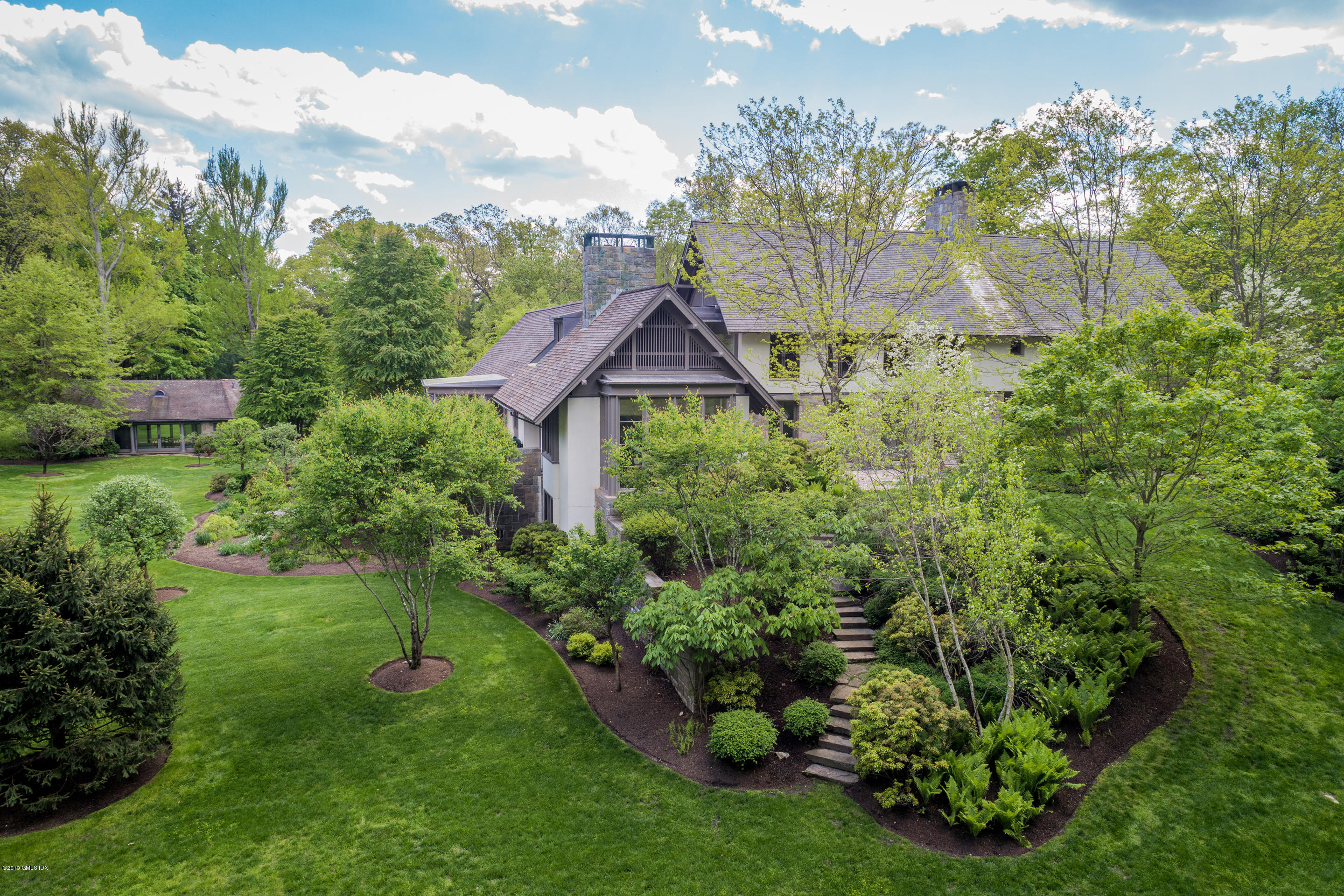 373 Riverbank Road Stamford, CT 06903 - Photo 20 of 35 a aerial view of a house with a yard and garden
