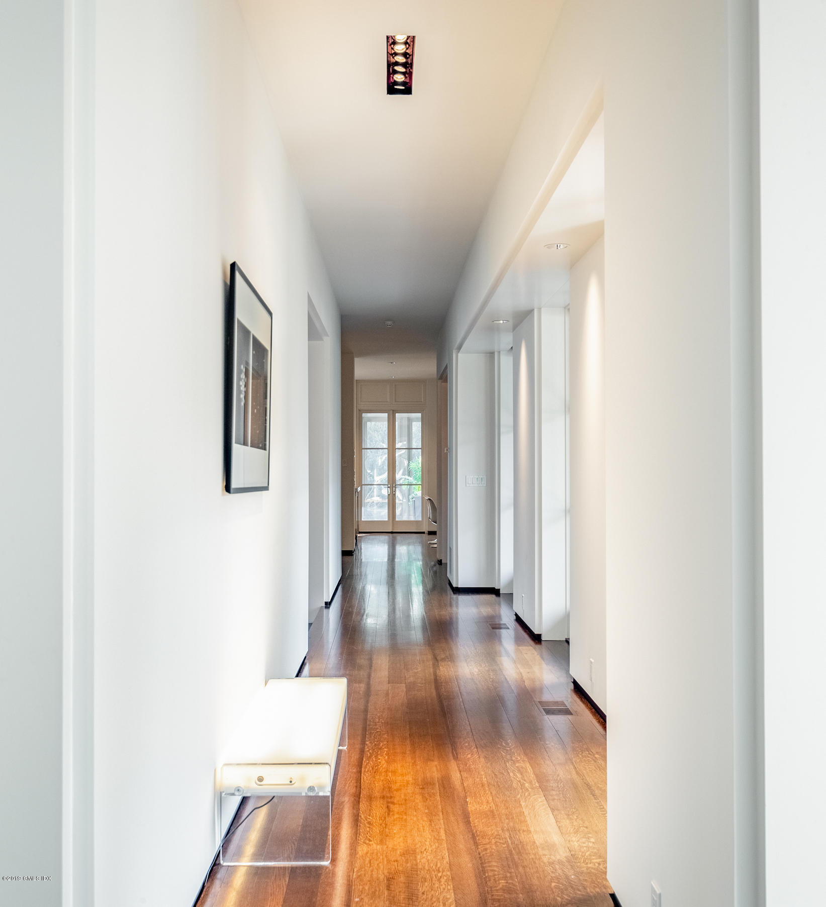 373 Riverbank Road Stamford, CT 06903 - Photo 2 of 35 a view of a hallway with wooden floor