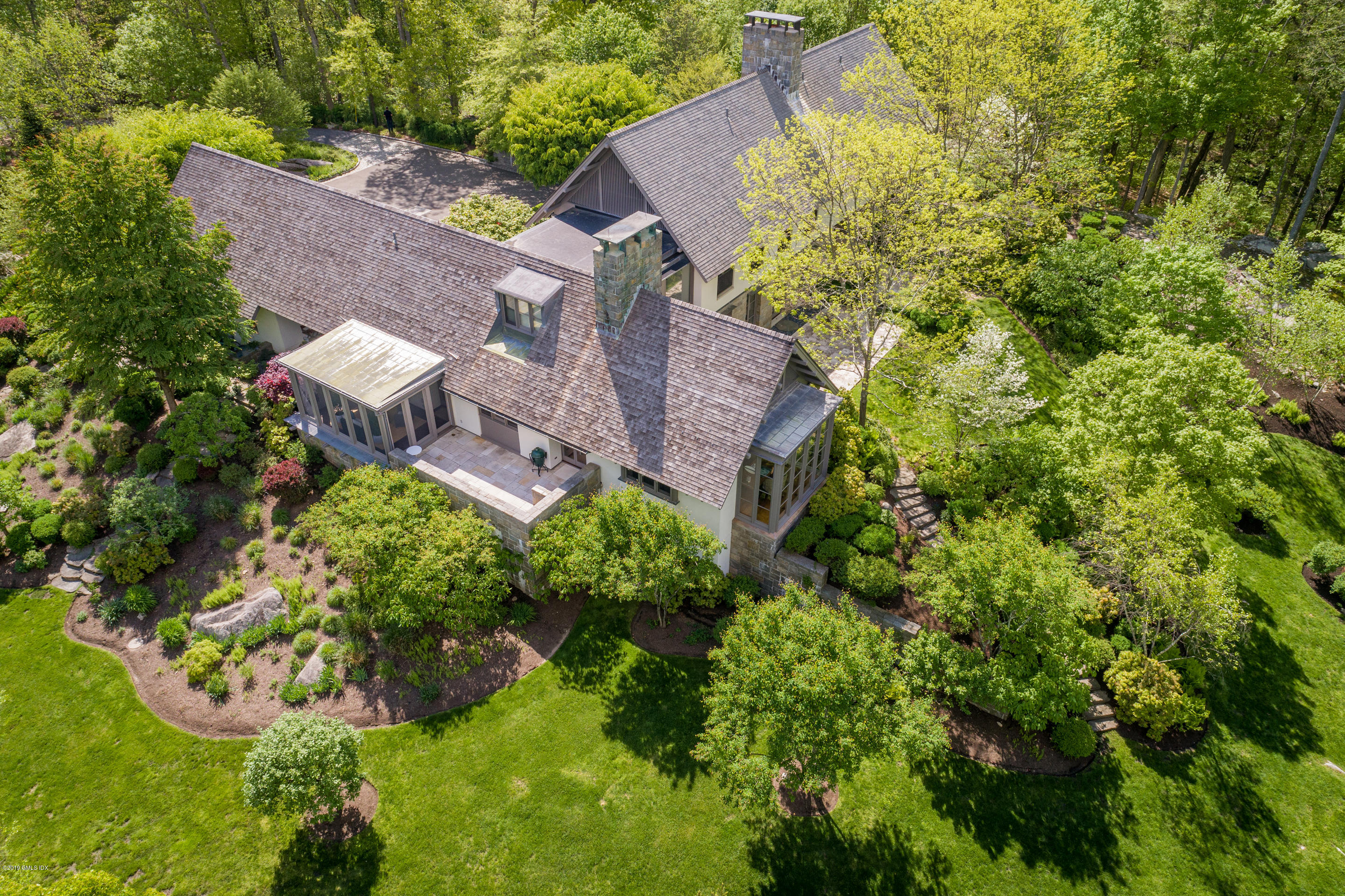 373 Riverbank Road Stamford, CT 06903 - Photo 21 of 35 an aerial view of a house with a garden and plants