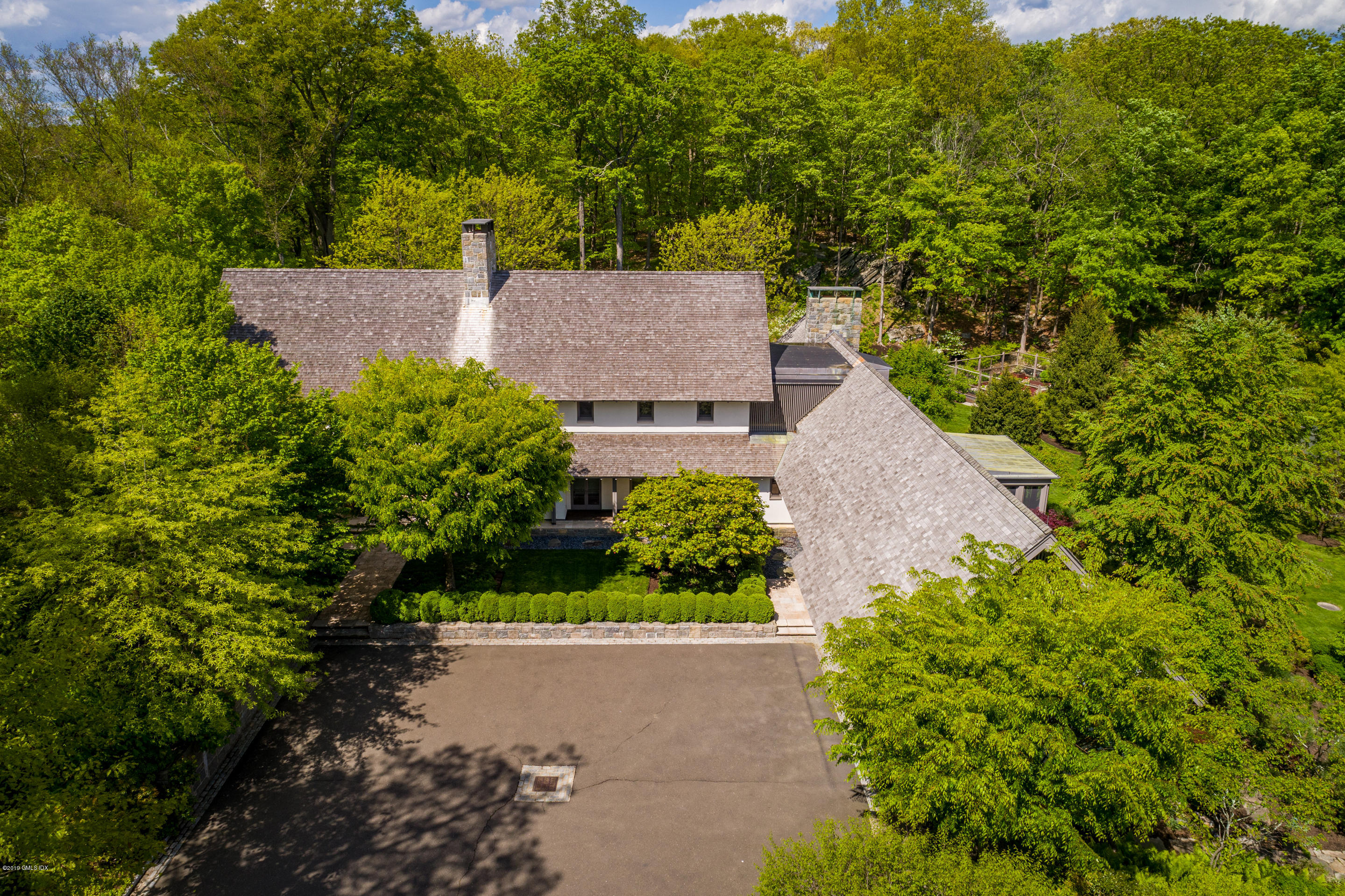 373 Riverbank Road Stamford, CT 06903 - Photo 22 of 35 an aerial view of a house with a yard and garden