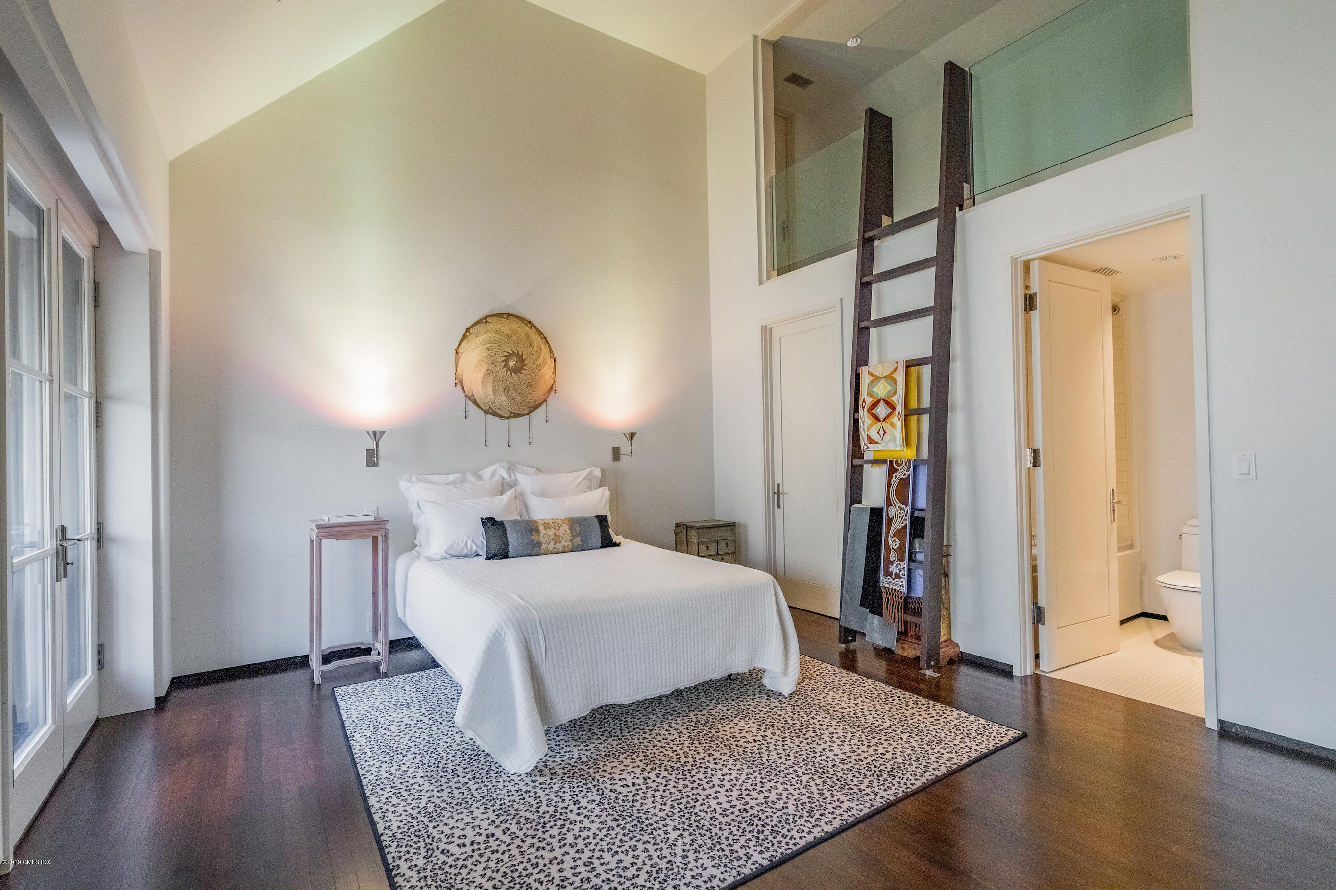 373 Riverbank Road Stamford, CT 06903 - Photo 30 of 35 a bedroom with a bed and wooden floor