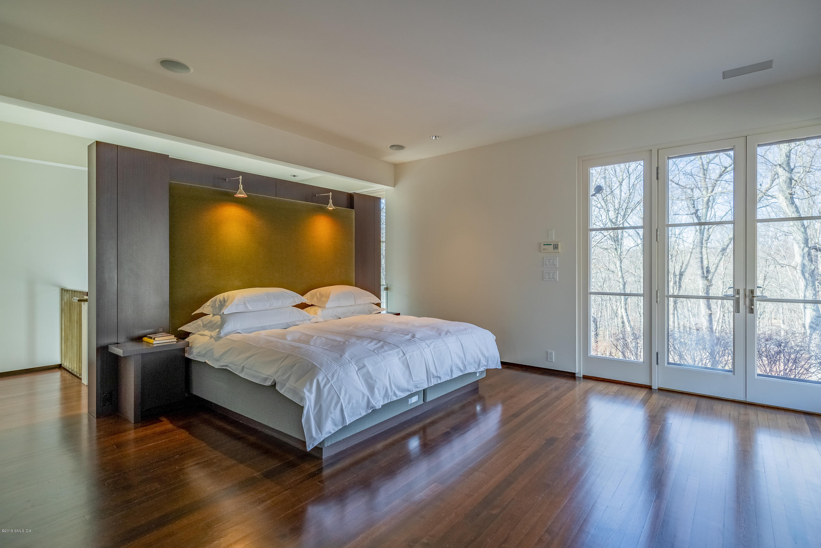 373 Riverbank Road Stamford, CT 06903 - Photo 33 of 35 a bedroom with a large bed and a large window